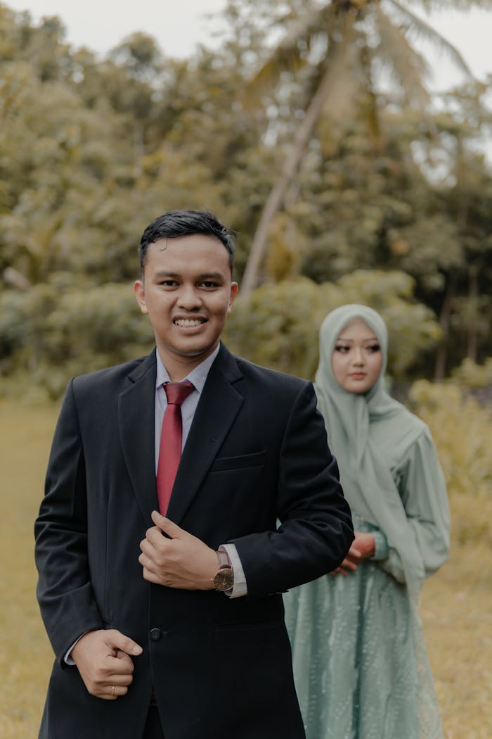 A happy couple in elegant attire during an outdoor wedding photoshoot in Pacitan, East Java, Indonesia.